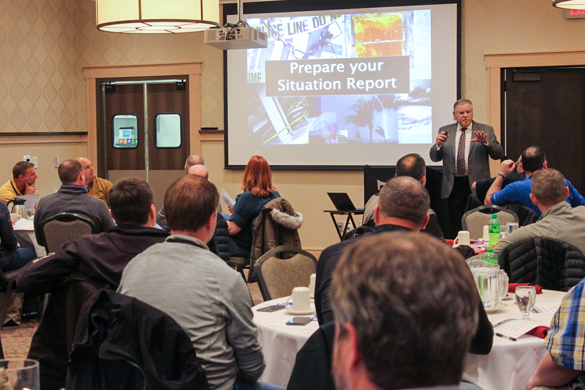 Employees sitting in banquet room during disaster response exercise