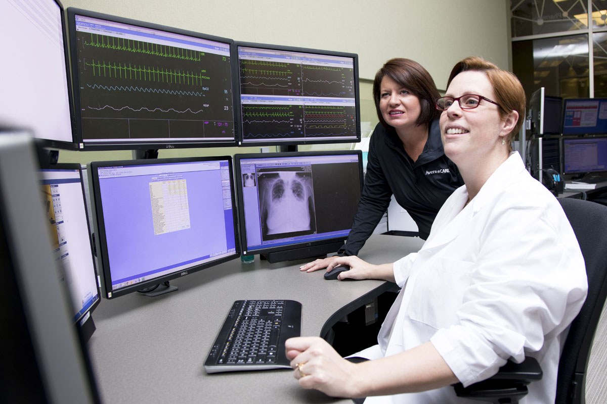Avera eCARE telehealth workstation with two women reviewing screens
