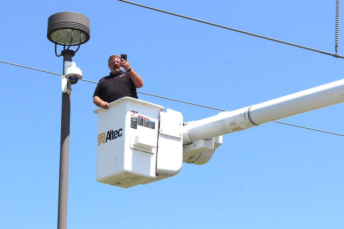 Brad Engbarth in a bucket lift taking photos from up above