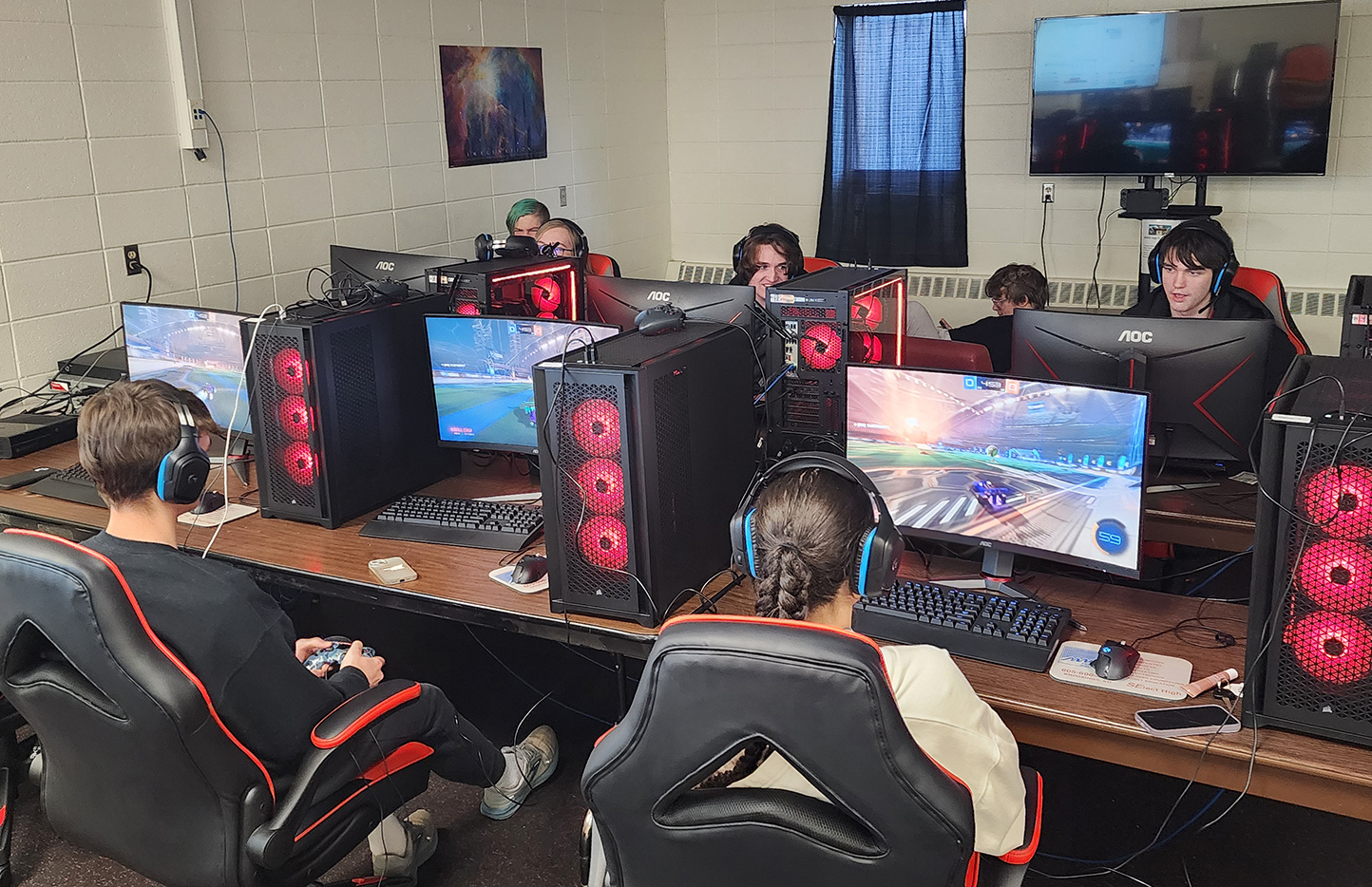 High school students sit in front of computers and play "Rocket League" during an esports event.