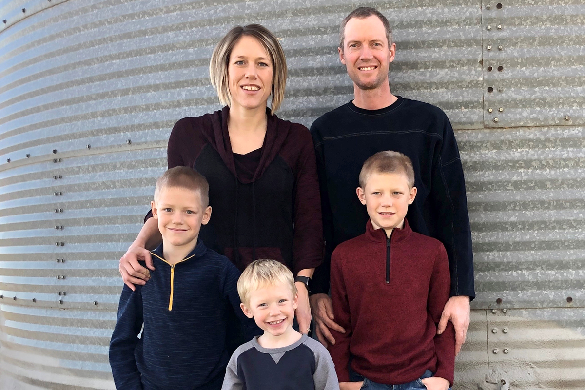 Culver family photo in front of grain bin as backdrop