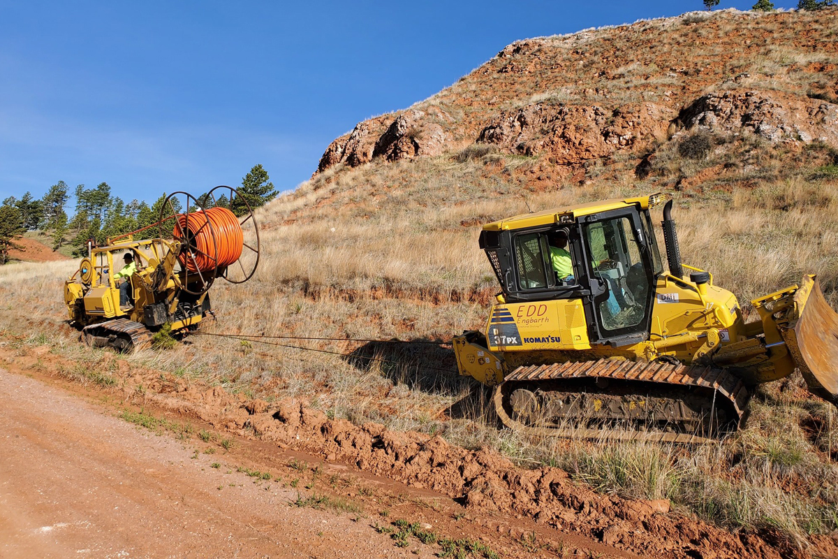 Engbarth crews installing fiber into red rocky ground