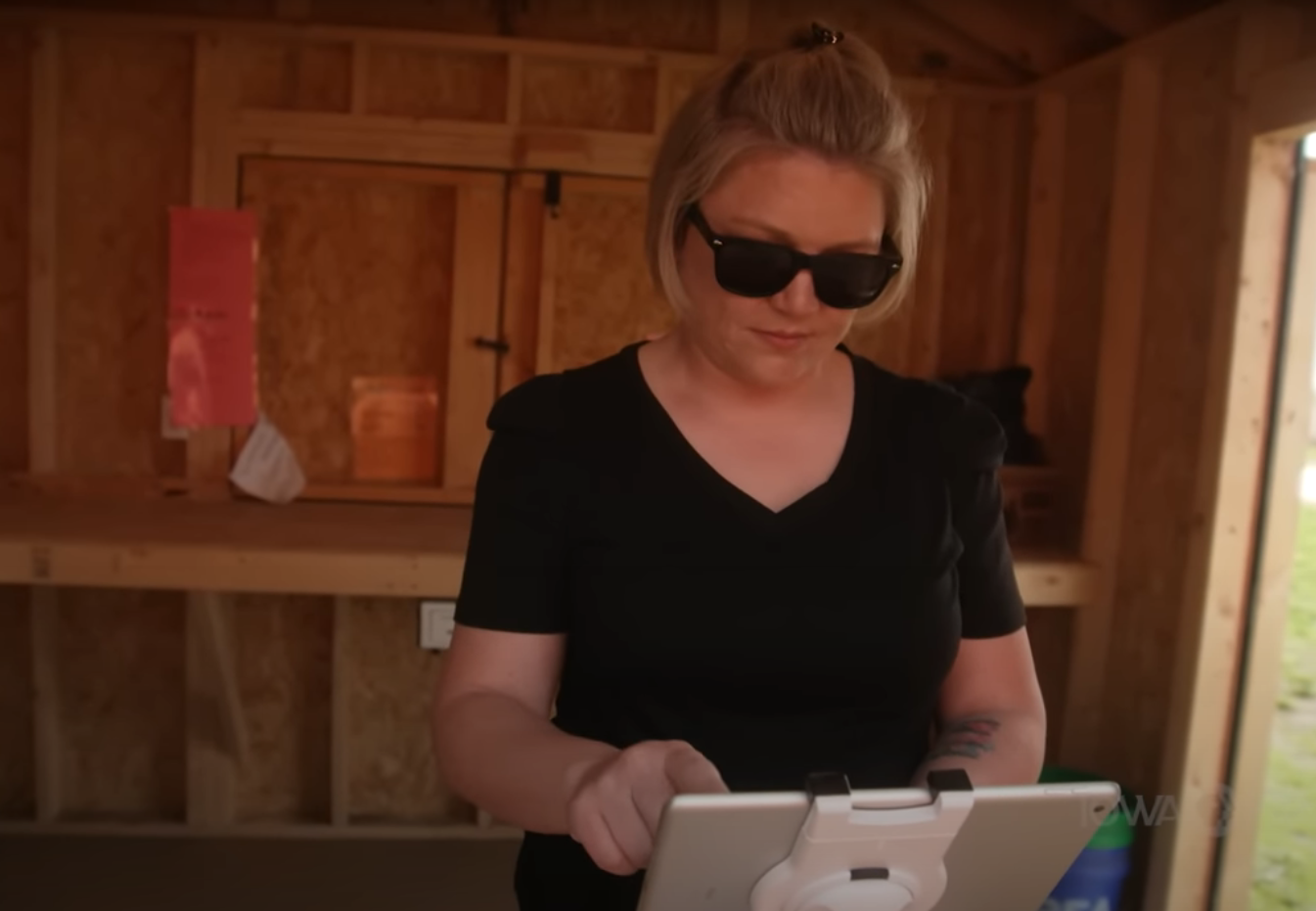 Big Stone Pumpkin Patch owner Emily Mueller runs a credit card through a card reader