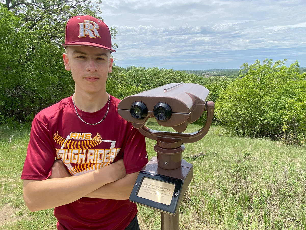 Teenager stands next to a viewfinder at Great Bear Recreation Park in Sioux Falls