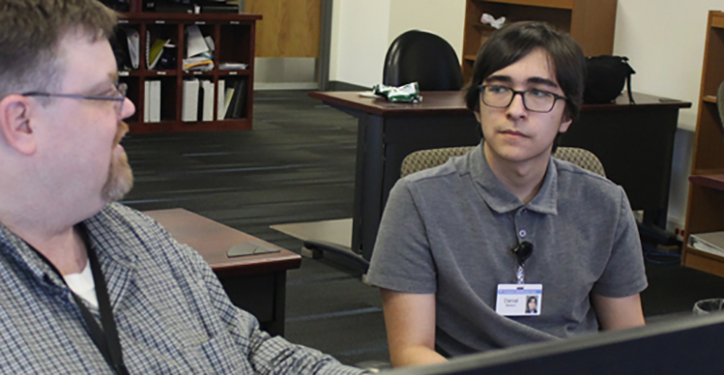 Danial Madson (right) listens to SDN Managed Services Data Technician Graham Wilson