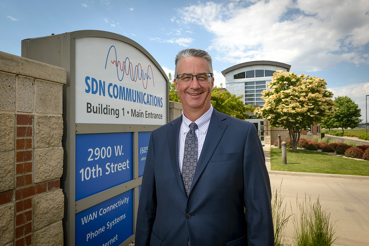 Mark Shlanta, former CEO of SDN Communications standing in front of the headquarters
