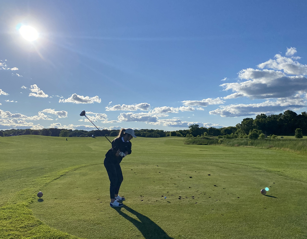 Megan Williams on the golf course with a blue sky in the background