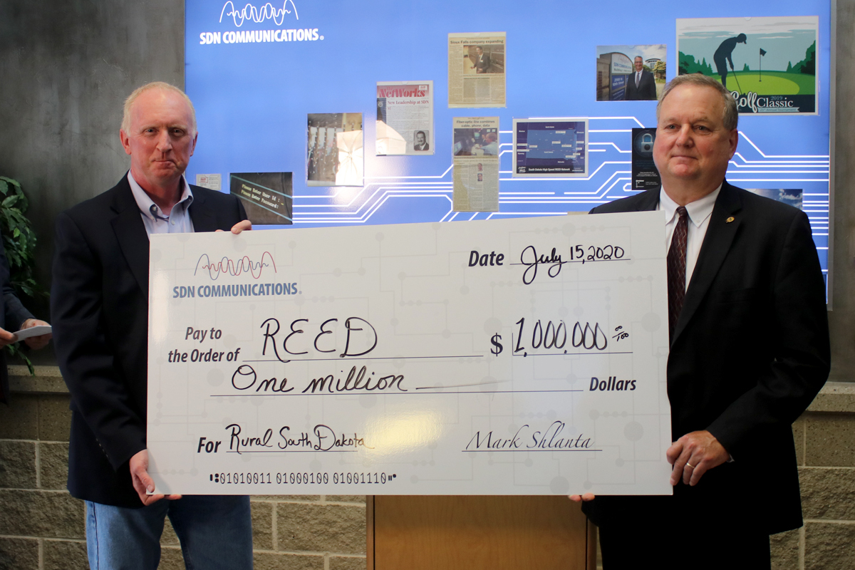 Check presentation from SDN Board President Denny Law to East River Electric's Tom Boyko