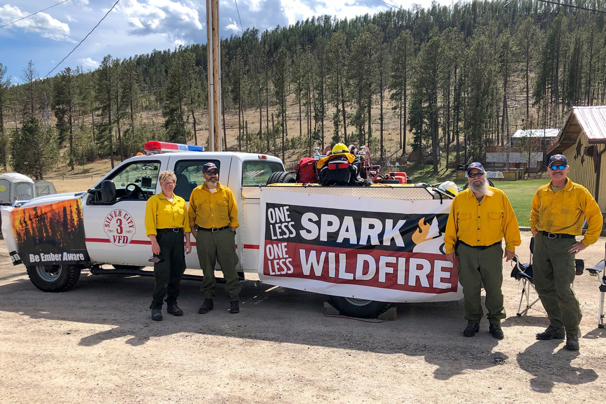 Silver City Volunteer Fire Department with truck and banner to prevent fires