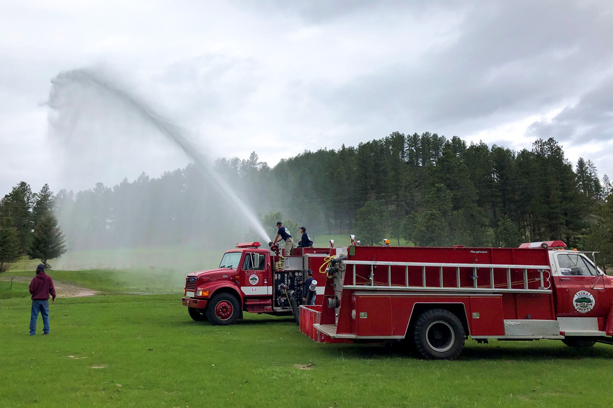 Silver City Volunteer Fire Department spraying a grassy area