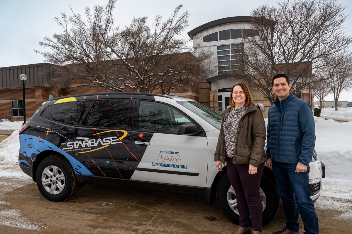 SDN Communications employees with STARBASE vehicle