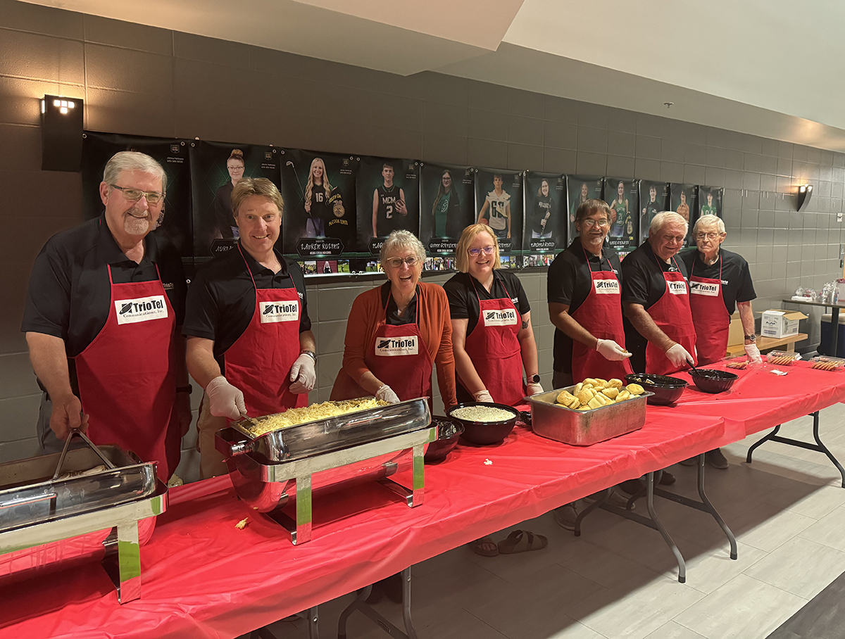 TrioTel Communications board members serve food during the company's annual meeting.