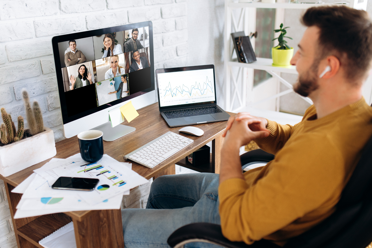 Man participating in video conference from home office.