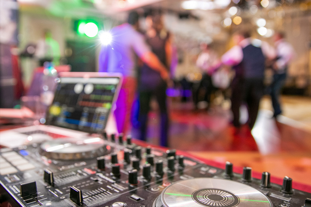 DJ's turn tables at a wedding dance