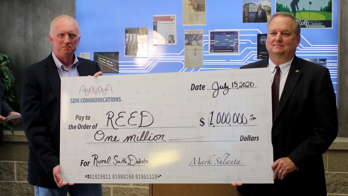 Check presentation of one million dollars by SDN board president Denny Law to East River Electric's Tom Boyko