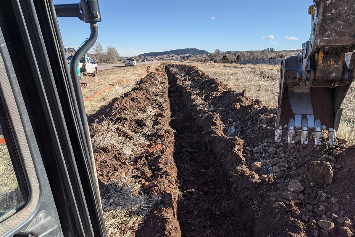 Fiber conduit trench through cobblestone in Sturgis