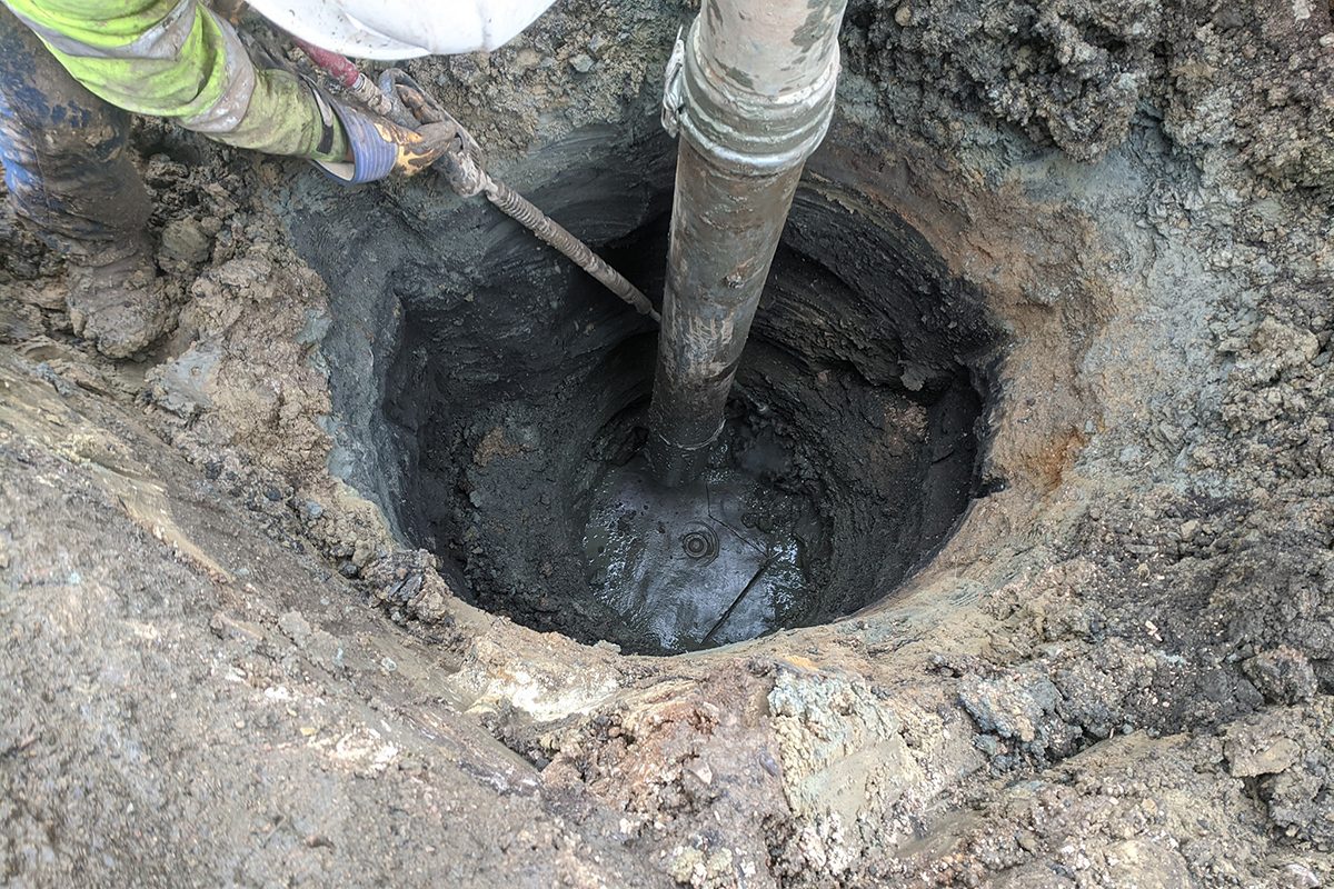 Cleaning out light pole base at Lincoln High School