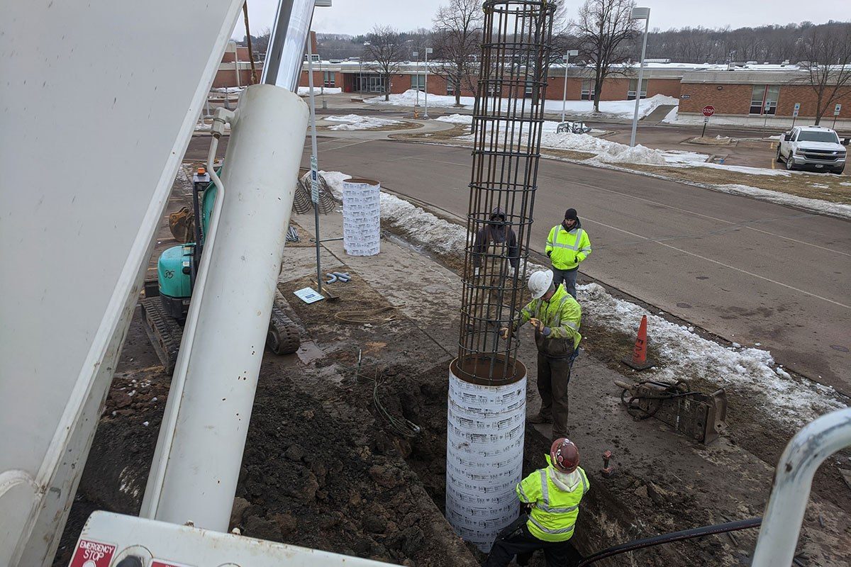 Setting new small cell pole base at Lincoln High School