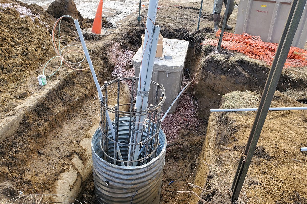 Crews working on the base for small cell poles at Washington High School in Sioux Falls