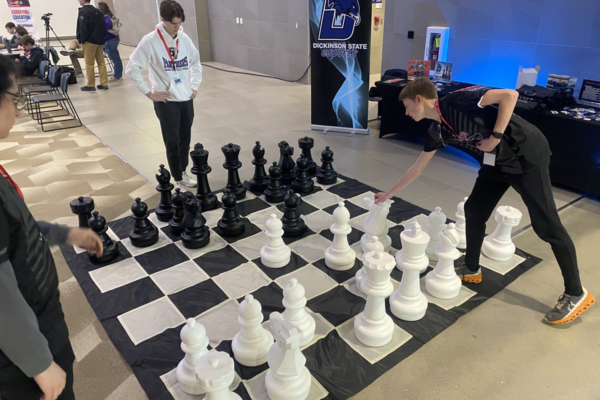 High school students play a large game of chess at the South Dakota esports state tournament