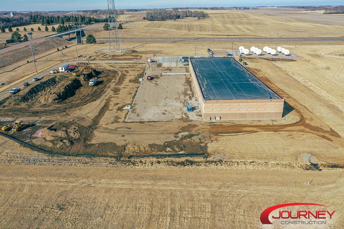aerial showing cement outline of second pod's foundation to the west of the existing building