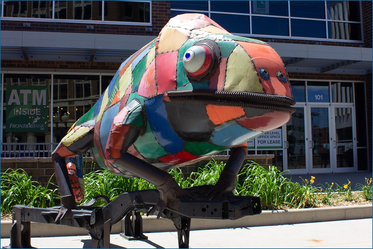 large chameleon made of a patchwork of brightly colored metal plates