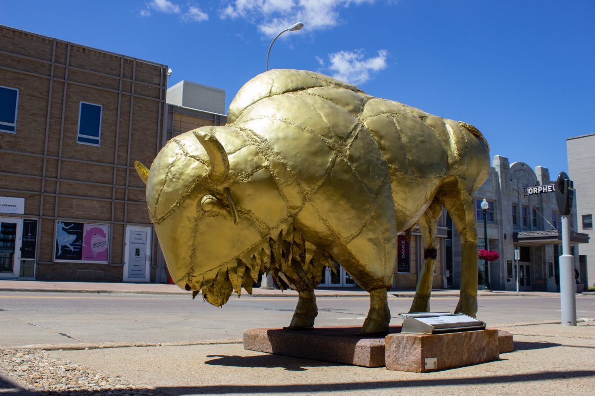larger-than-life shiny golden steel statue of a buffalo
