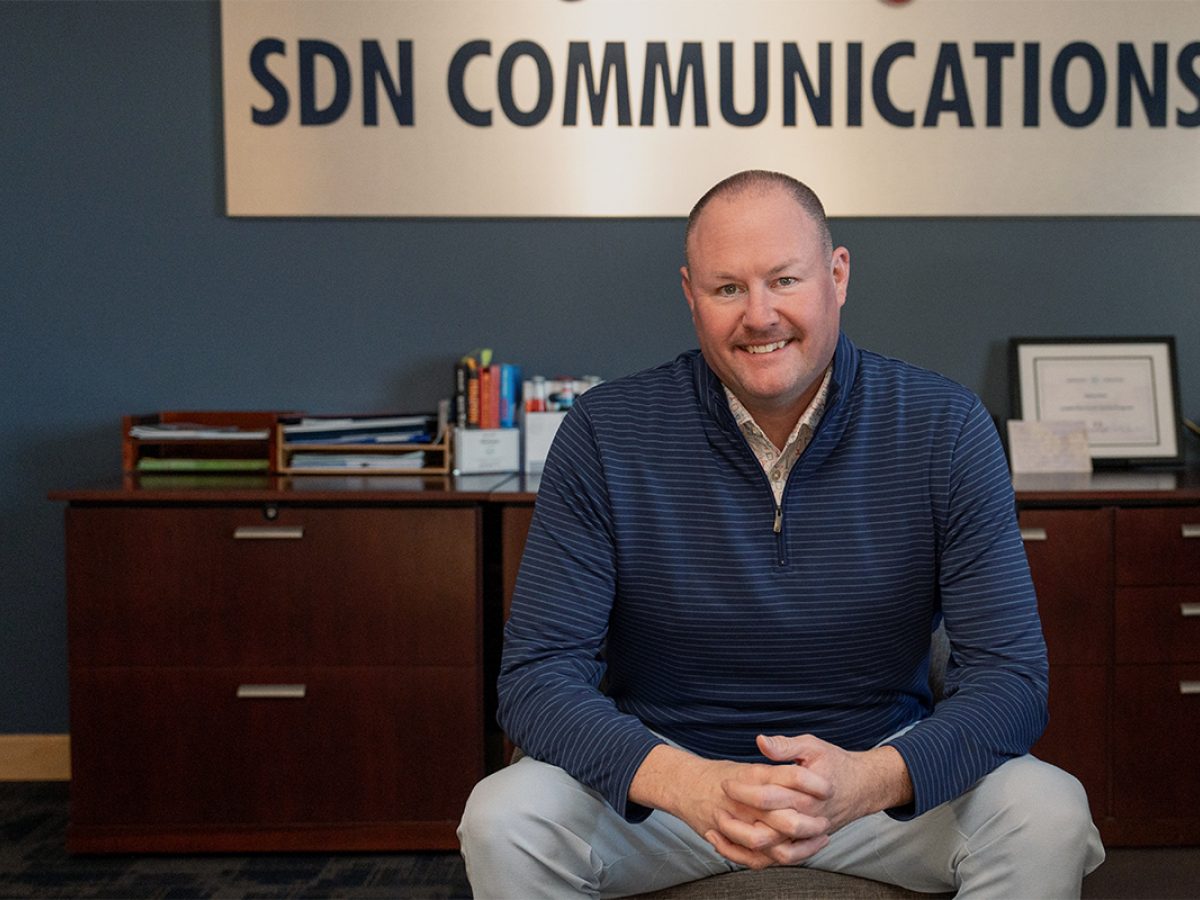 SDN Communications CEO Ryan Punt poses for a photo in his office