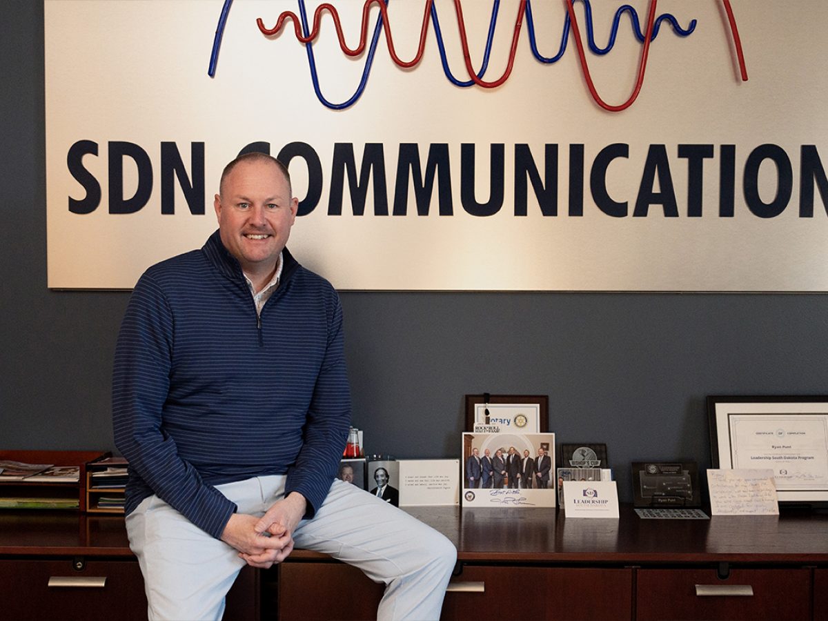 SDN Communications CEO Ryan Punt poses for a photo in his office