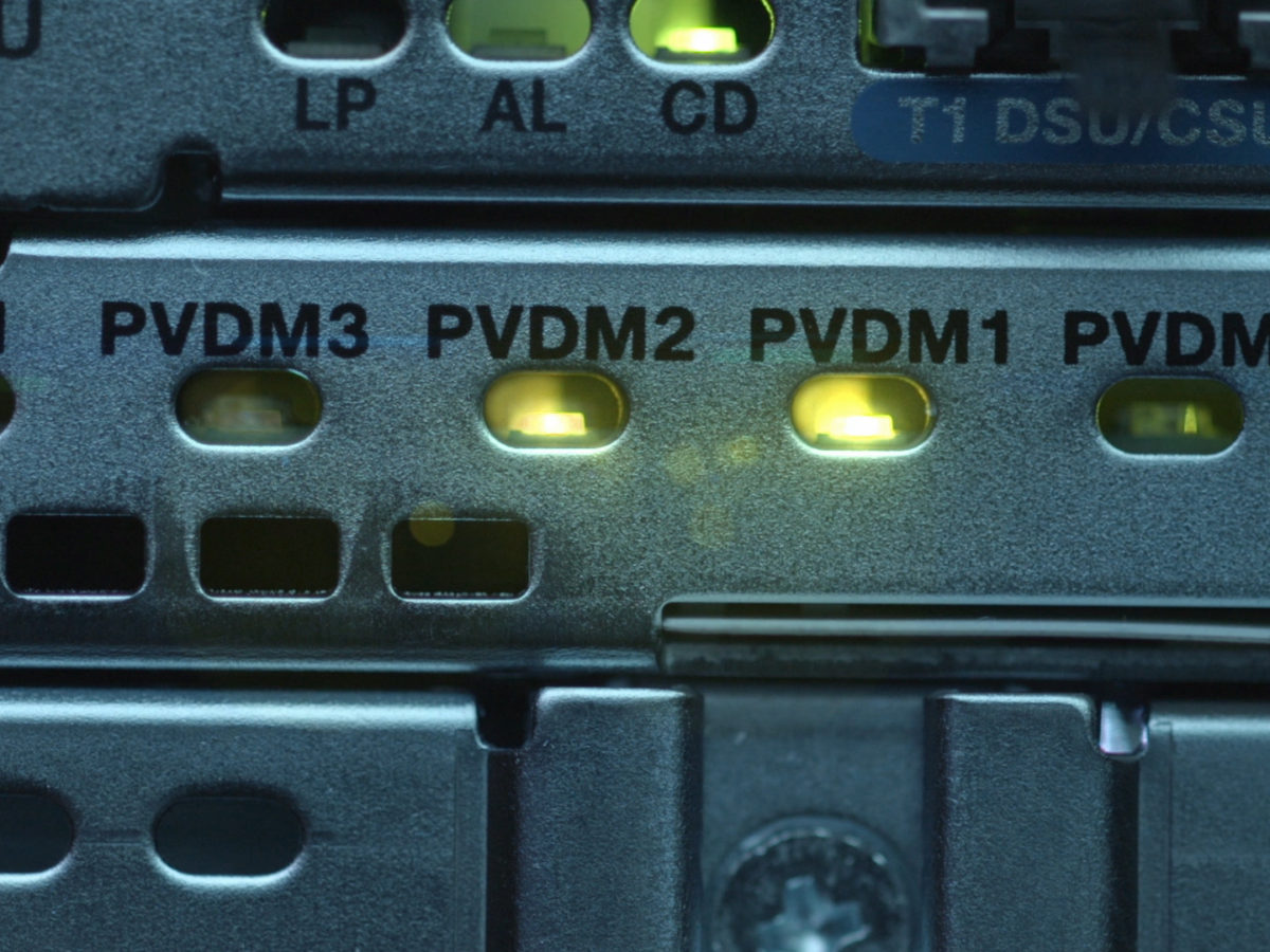 Close up image of green lights lit up on a router