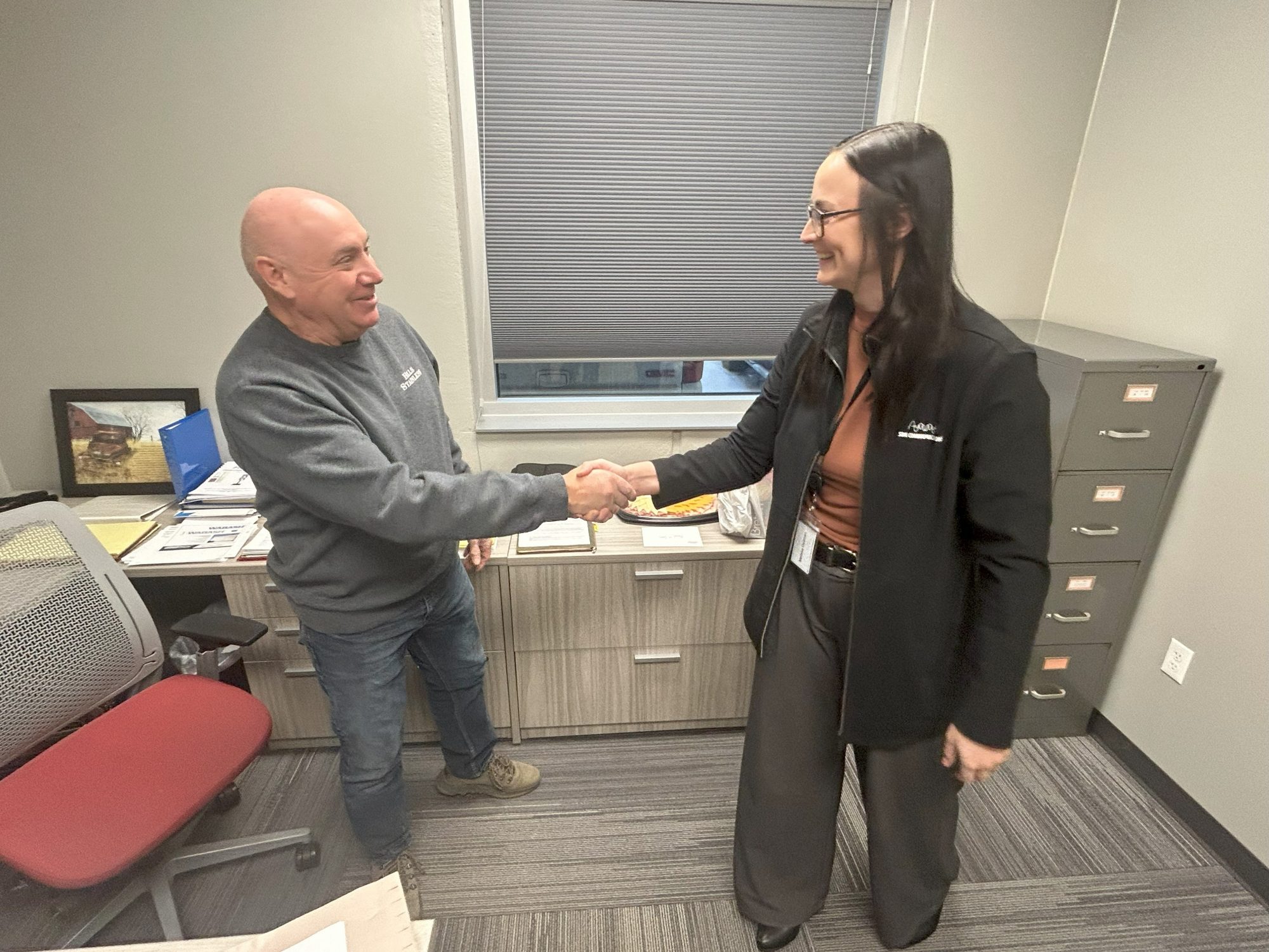 Hills Stainless Steel General Manager Brad Vaughn greets SDN Communications Network Account Executive Melissa Dellman