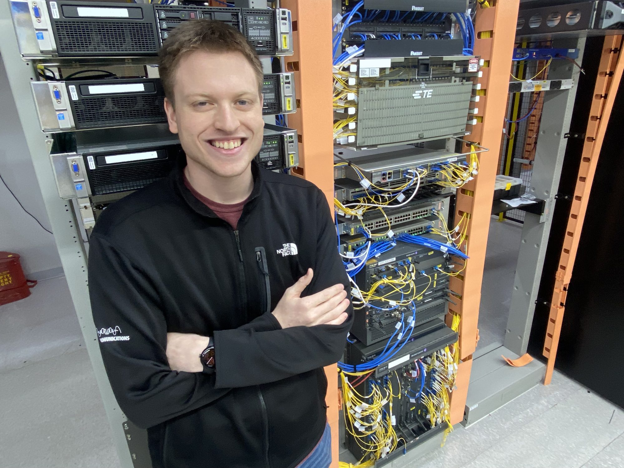 SDN Communications' Brady Andersen poses for a photo in a server room