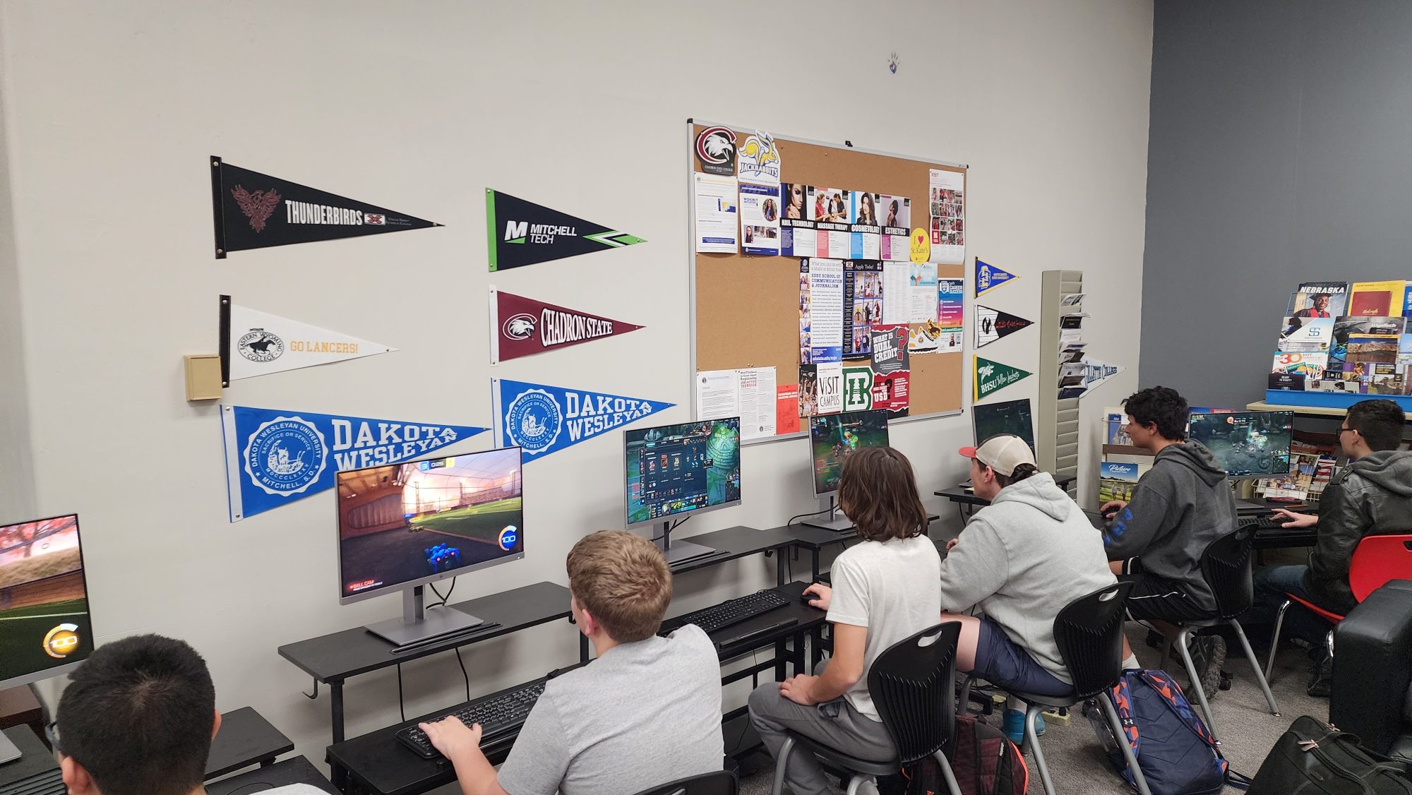 High school students compete play games on computers in a lab