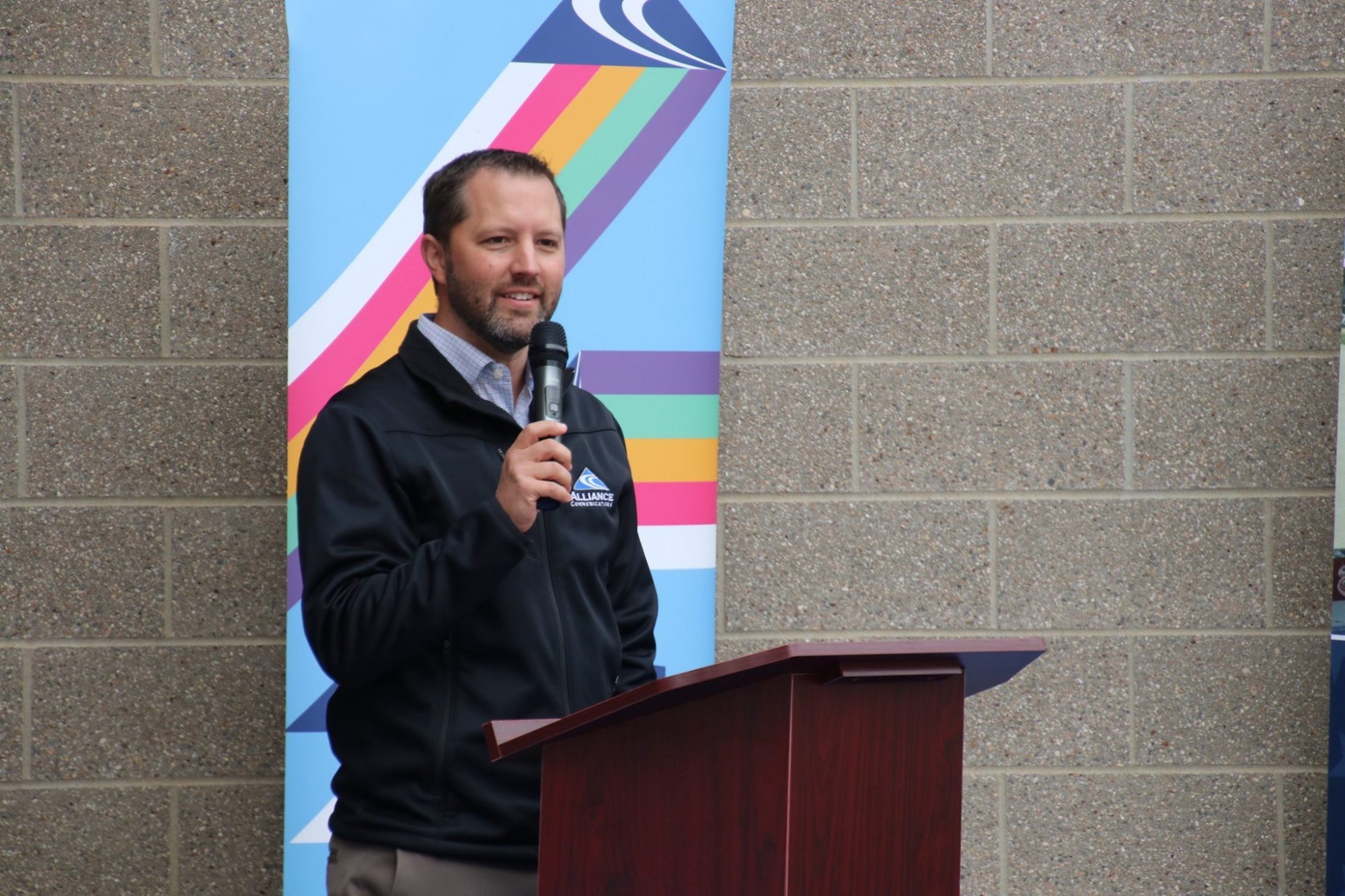 Alliance CEO/GM Ross Petrick stands behind a podium