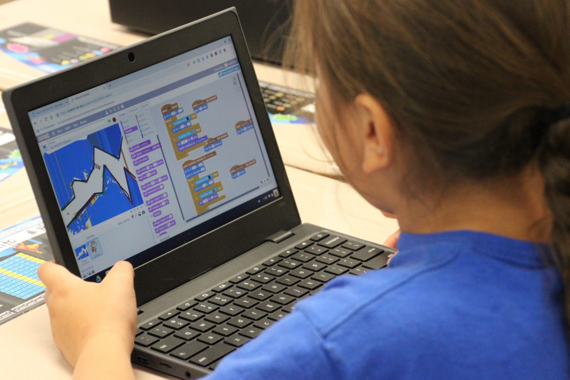 student with laptop in classroom