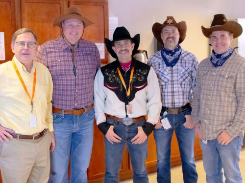 Group photo of Jay Powell, Ryan Punt and Five-Star Call Center staffers in western gear