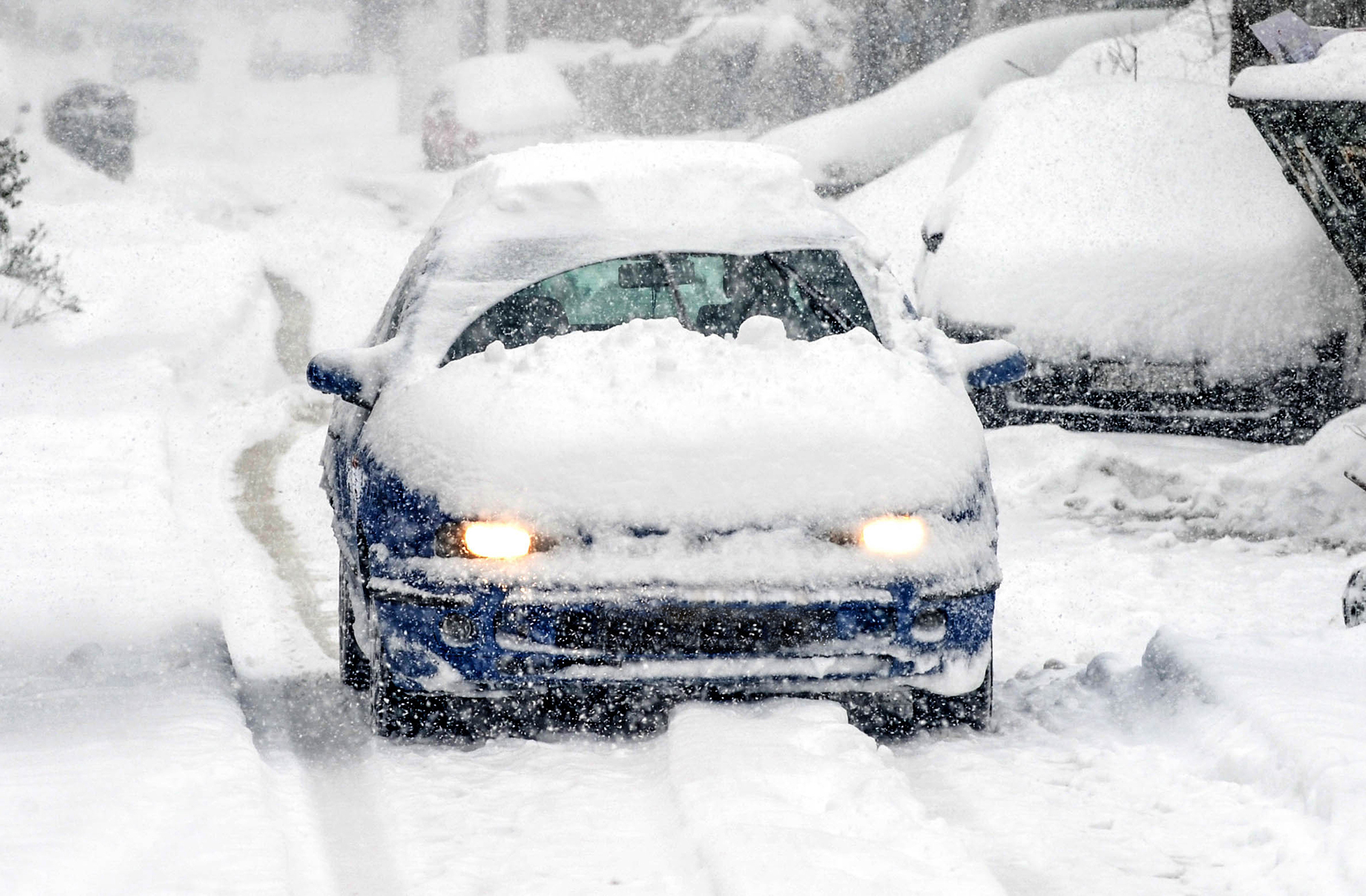 Car driving in winter storm